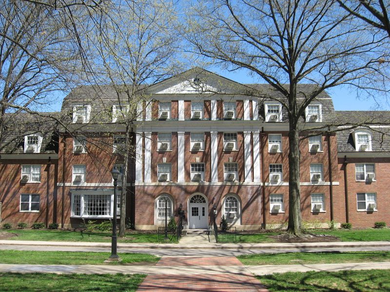 Large brick residence hall with white columns